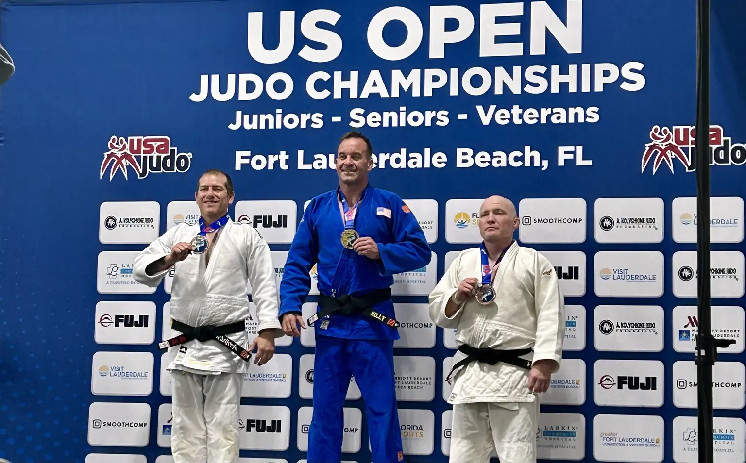 Billy Gavigan standing on the gold-medal podium at the 2024 U.S. Open Judo Championships
